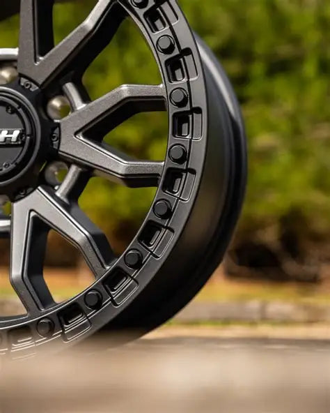 Sculpted dark alloy wheel with precision detailing